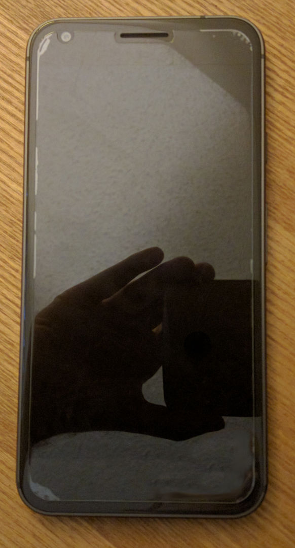 First attempt at applying the screen protector. Note the poor adhesion along the edges that distract from its look.